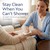 Caregiver using a no-rinse body cleansing cloth on an elderly woman's arm. SWATCH