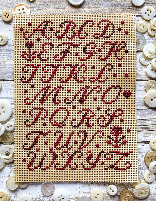 lucy beam love in stitches cross stitch red paper sampler cross stitch