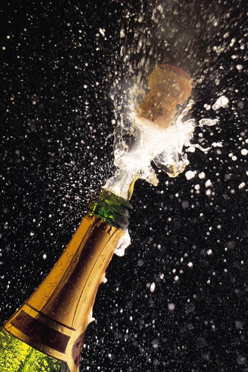 Image: sparkling wine explodes from bottle as cork is released THUMBNAIL